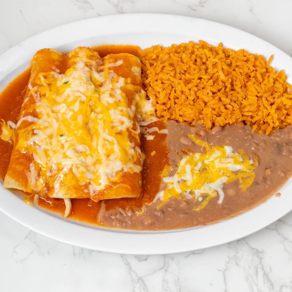 Three cheese enchiladas covered in red sauce and melted cheese, with sides of rice and refried beans.