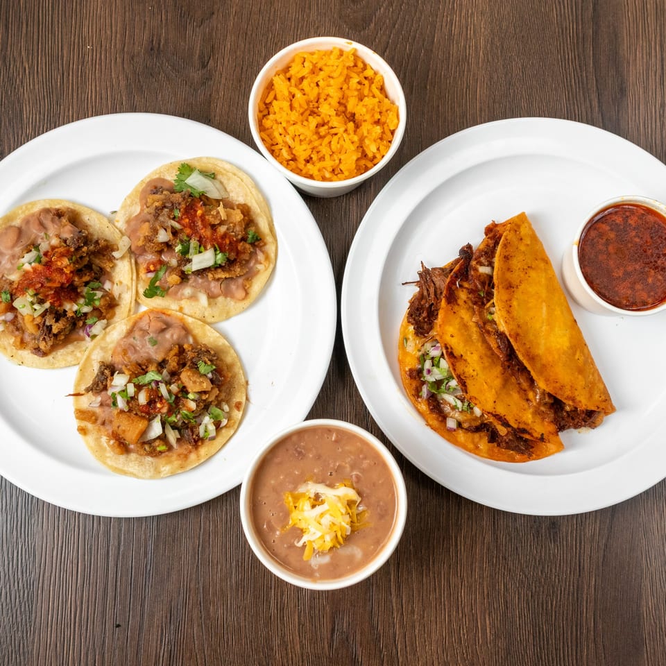Two plates of tacos, one with three street tacos, the other with two birria tacos and consommé.